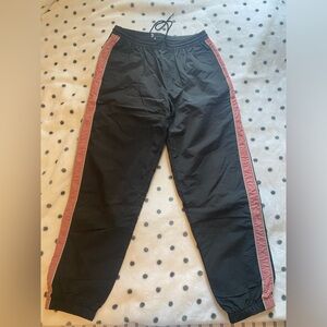 Urban Outfitters black with pink stripe pants size medium.
